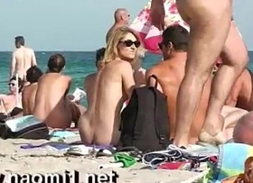 Naomi1 handjob a young guy on a public beach
